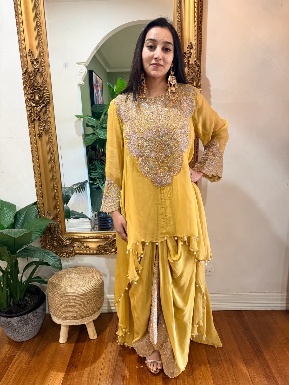 Embroidered dhoti skirt with asymmetrical top, intricately embroidered front view on model
