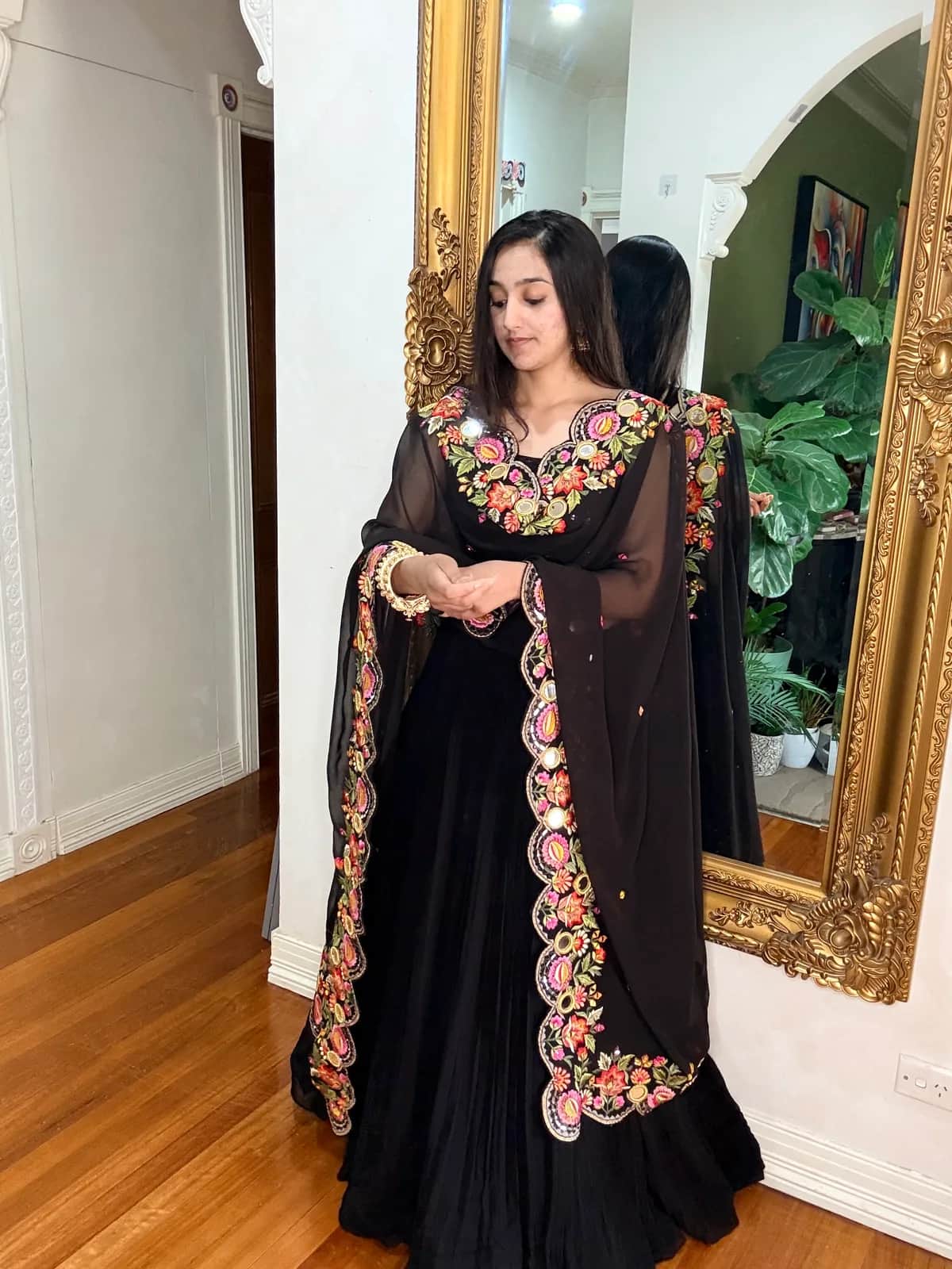 Black Sequin Blouse with Georgette Lehenga and Embroidered Dupatta front view on model