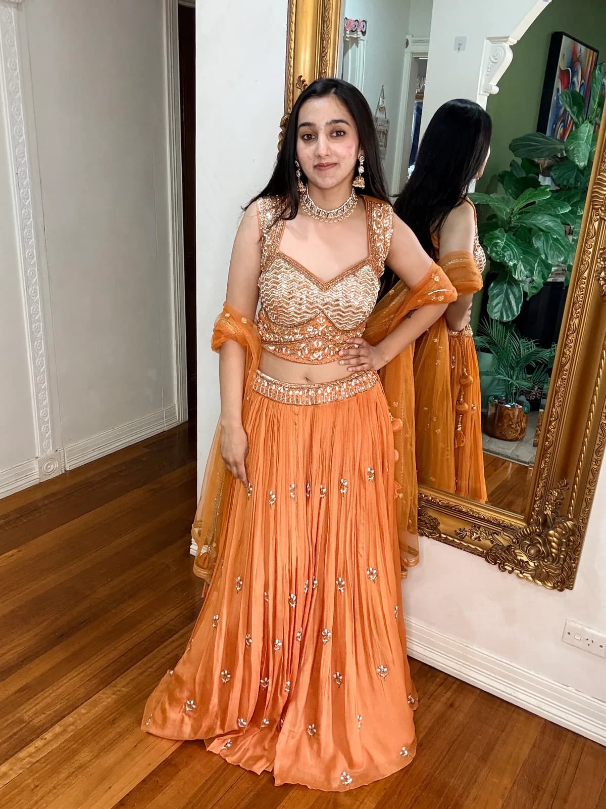 Orange Lehenga Choli Set with Booti Embroidery front view on model
